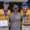 A last celebration: Indianola baseball coach joins two of his players who received honors during the All Star Series at the University of Iowa.